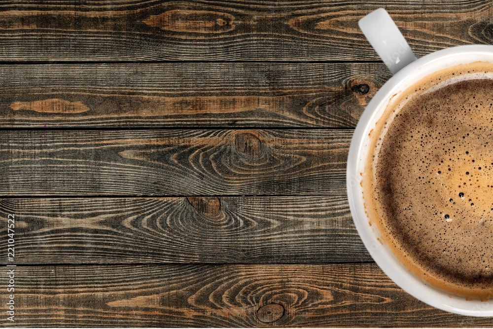 Cup of coffee on wooden background