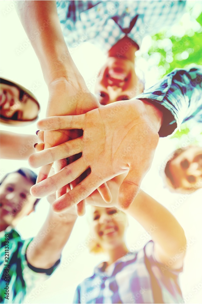 Large group of smiling friends staying together and looking at