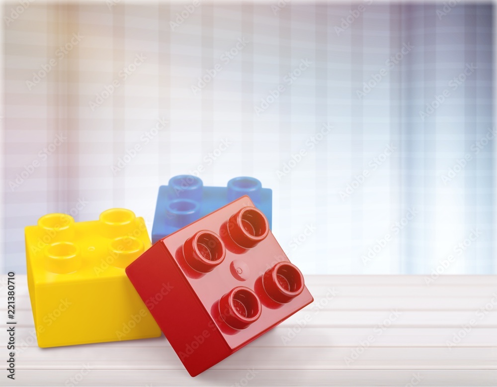 Colorful children building bricks on desk