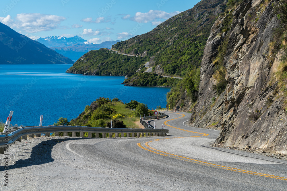 Winding Road along Mountain Cliff and Lake