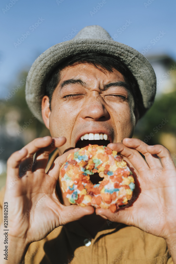 Happy man having a doughnut