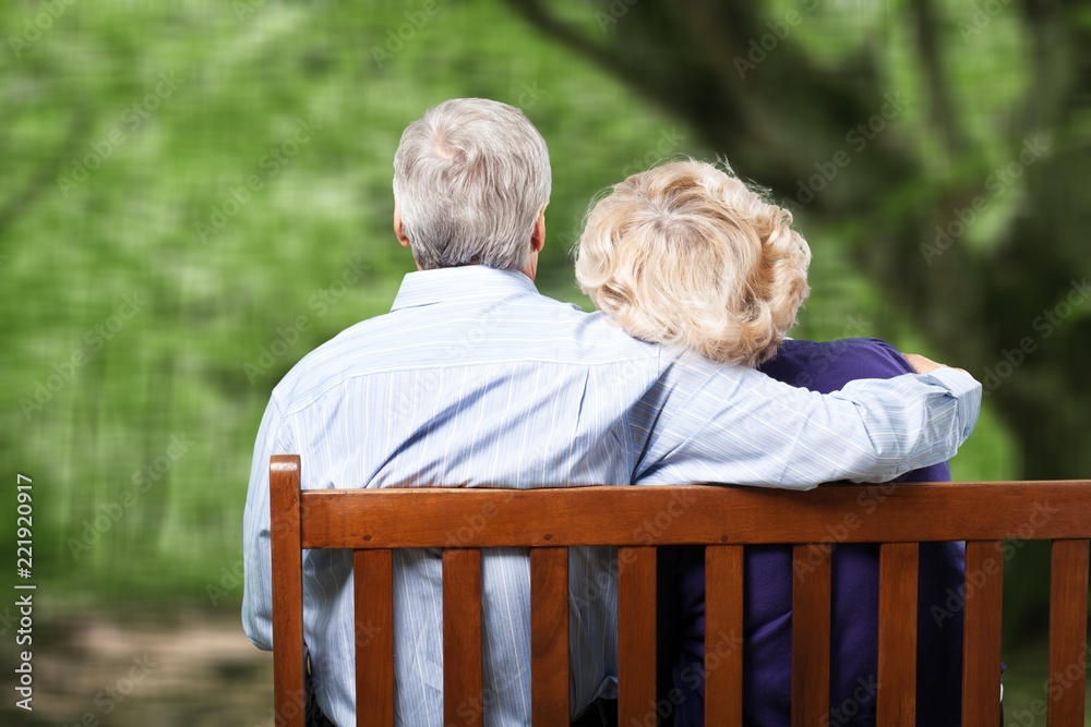 Portrait of happy senior couple in green