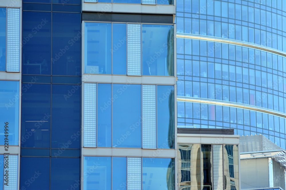 Abstract fragment of contemporary architecture, walls made of glass and concrete. Glass curtain wall