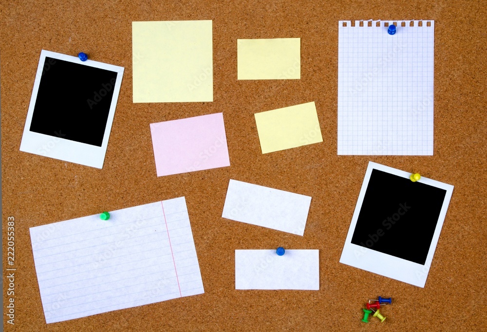 Bulletin board with with blank notes and photographs