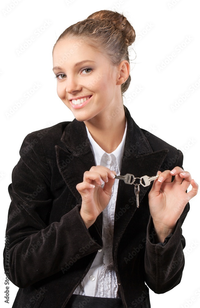 Beautiful young businesswoman holding house keys