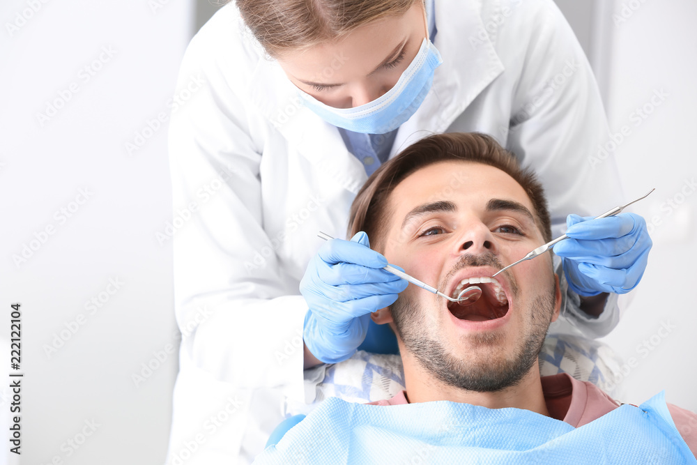 Dentist examining patients teeth in clinic