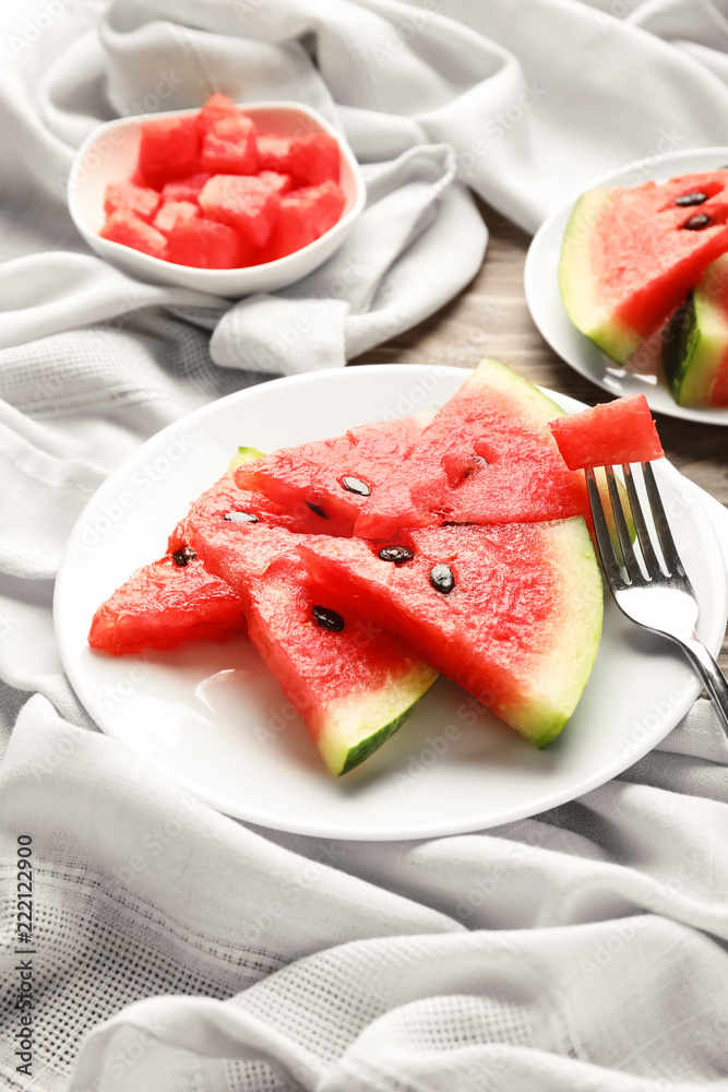 Plate with sweet watermelon slices on table