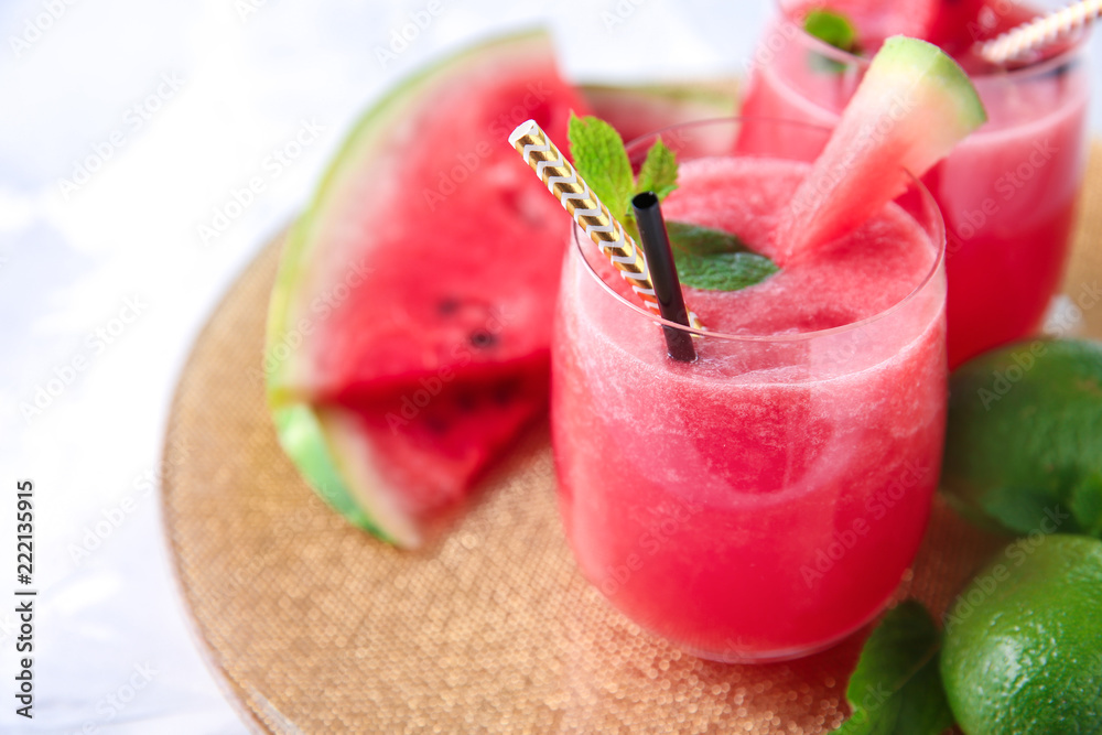 Glass with fresh watermelon smoothie on table