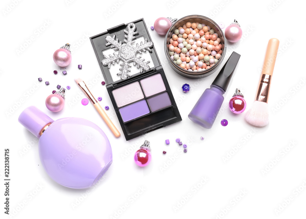 Set of cosmetics with Christmas decorations on white background