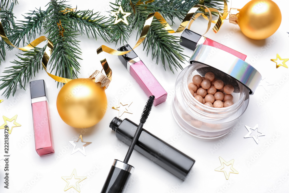 Set of cosmetics with Christmas decorations on white background