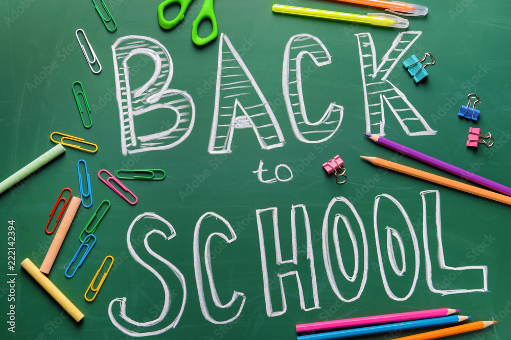 Stationery and words BACK TO SCHOOL written on chalkboard