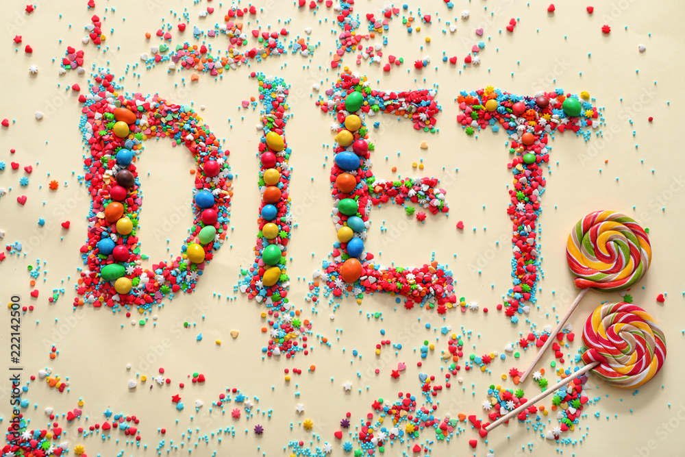 Word DIET made of color candies on light background