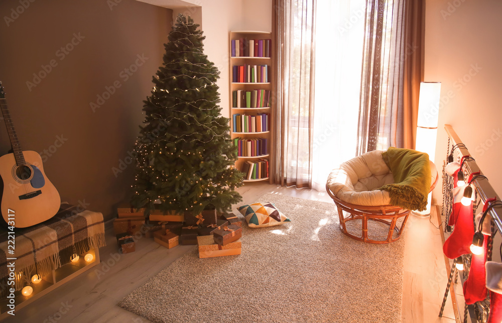 Stylish interior of room with beautiful Christmas tree