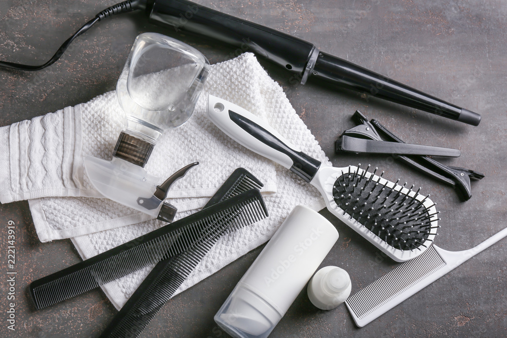 Professional hairdressers set with cosmetics on grey table