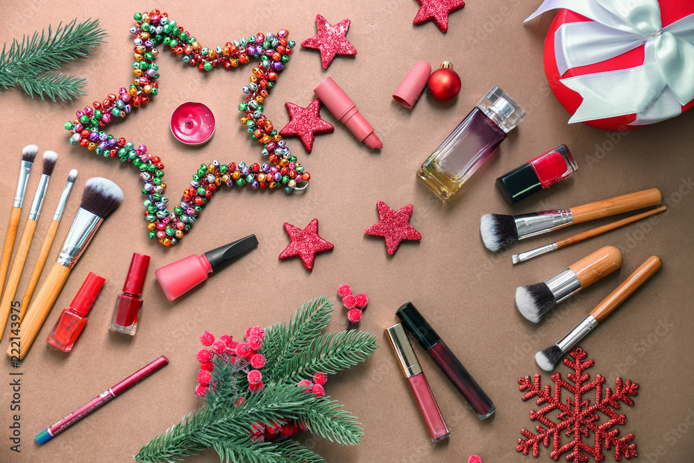 Set of cosmetics with Christmas decorations on color background