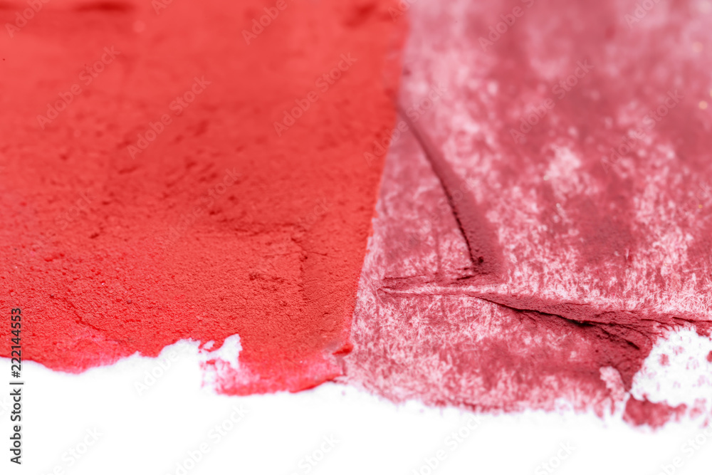 Samples of color lipsticks on white background, closeup