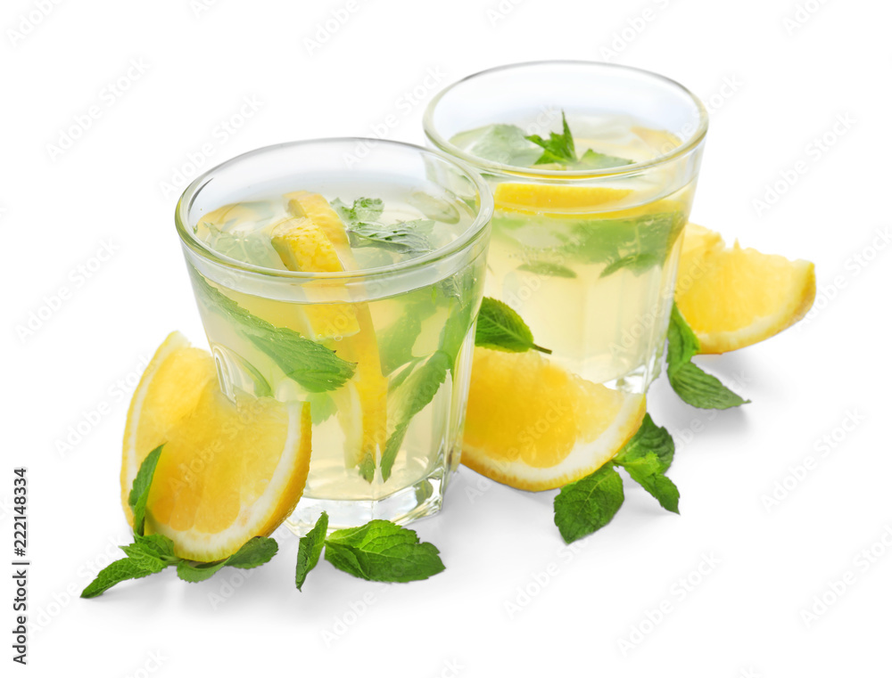 Glasses of fresh lemonade on white background