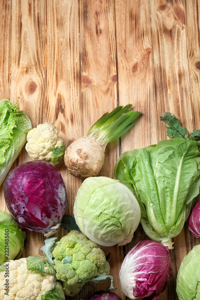 Different types of cabbage on wooden background