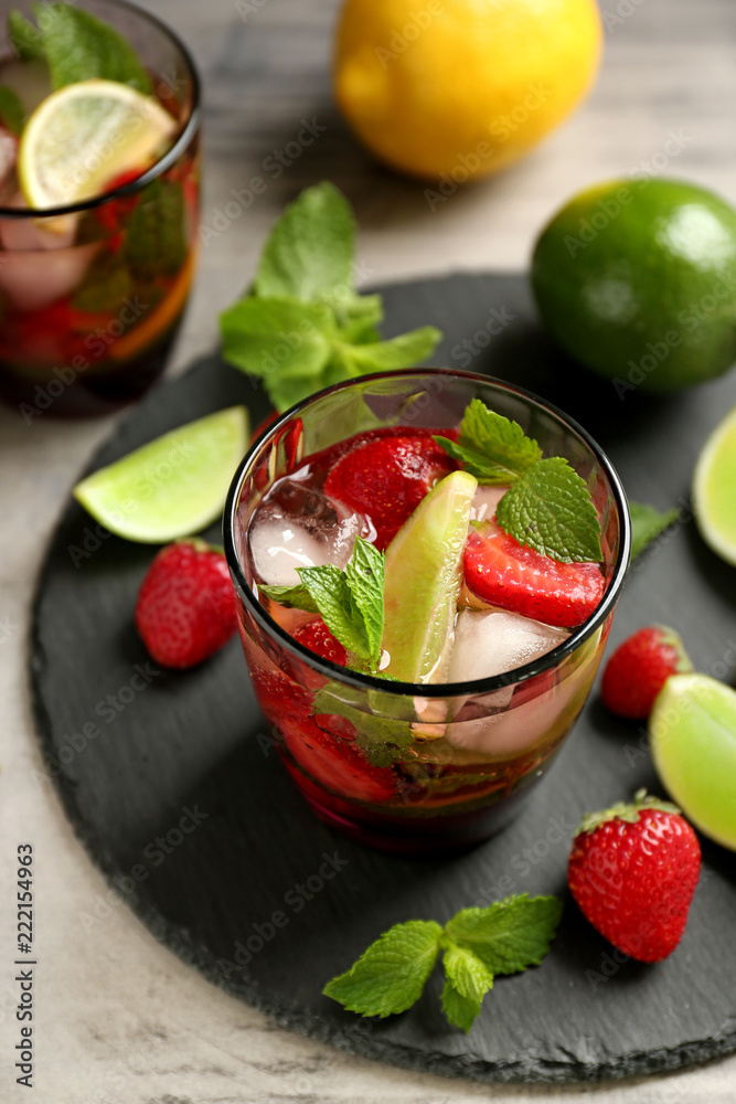 Glass of fresh strawberry lemonade on slate plate