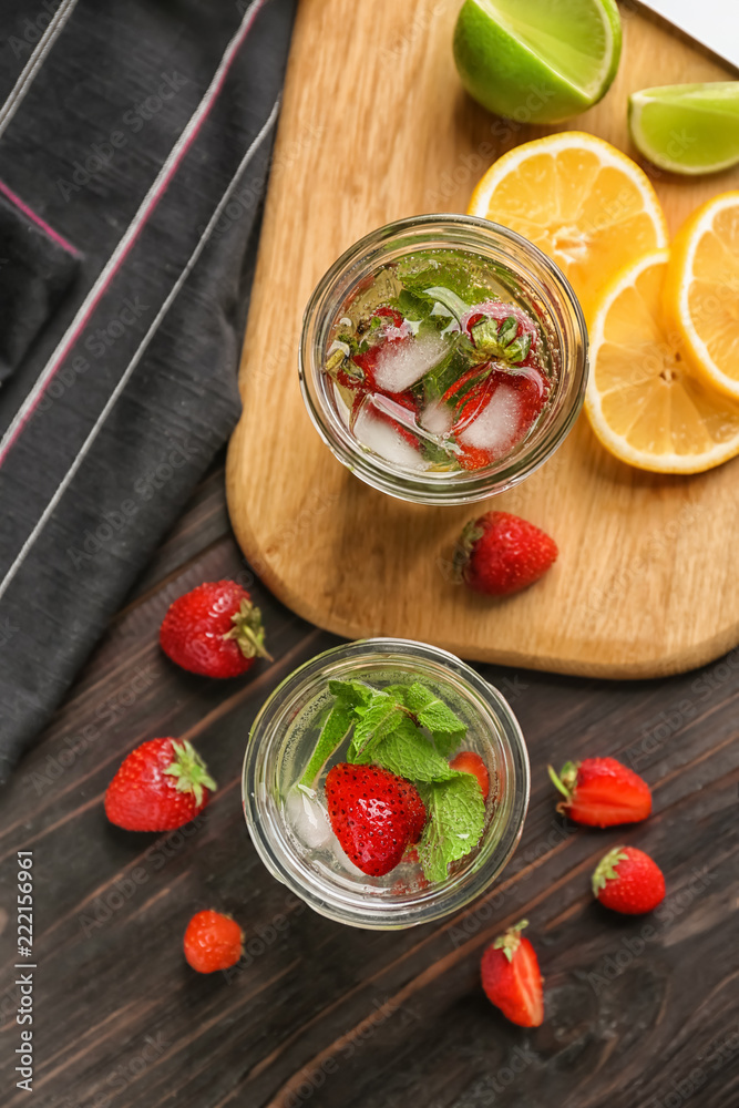 Jars of fresh strawberry lemonade on  wooden table