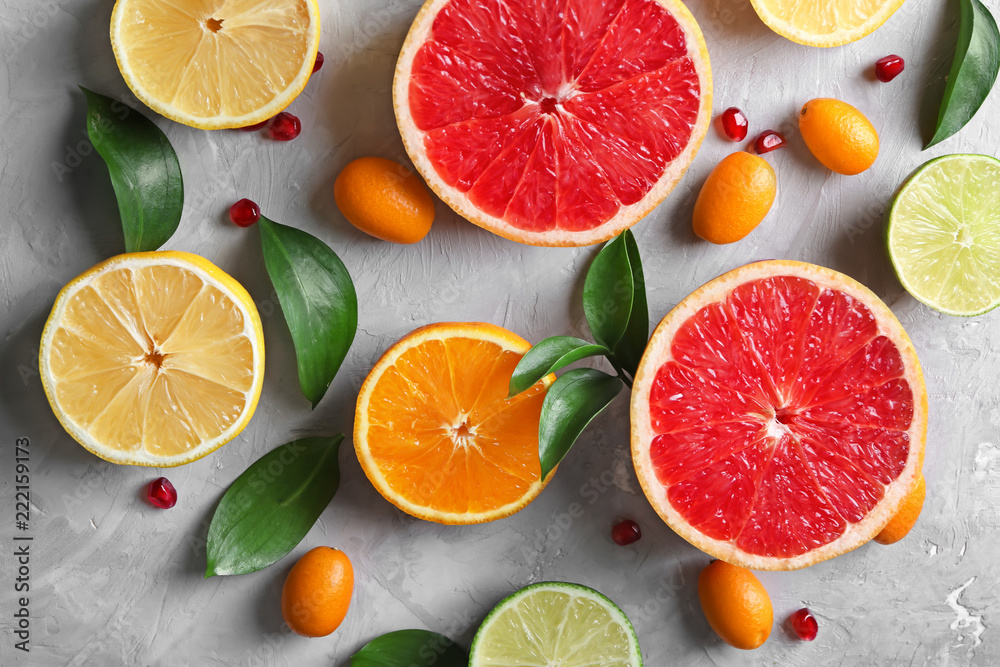 Flat lay composition with various delicious citrus fruits on light background