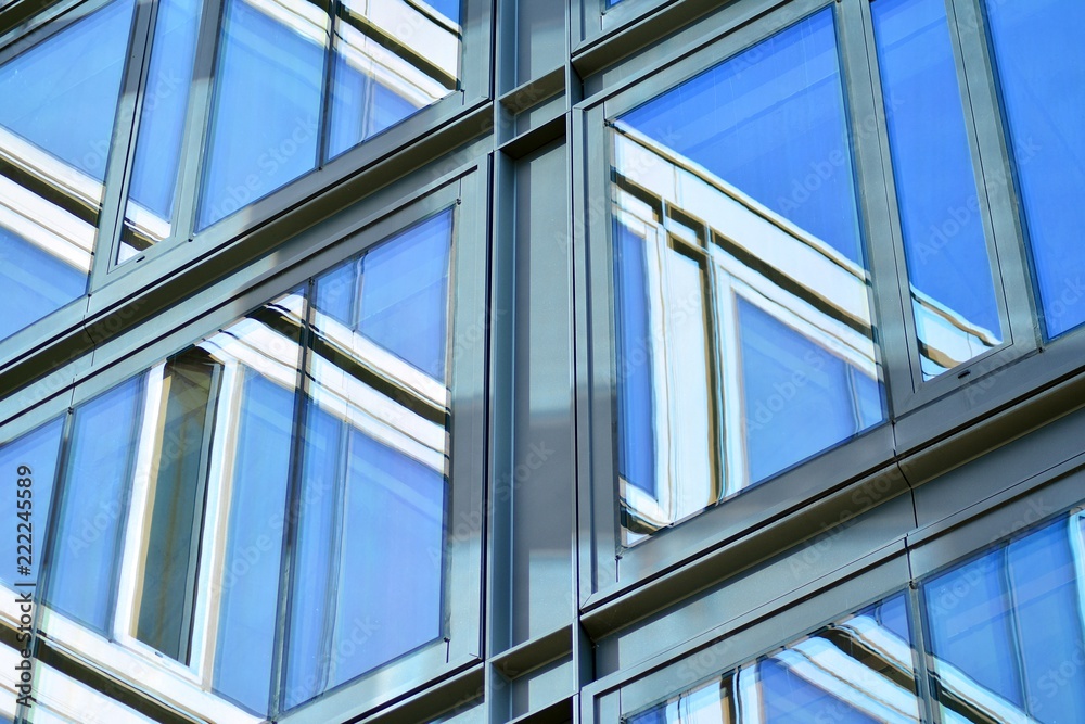 Abstract fragment of contemporary architecture, walls made of glass and concrete. Glass curtain wall