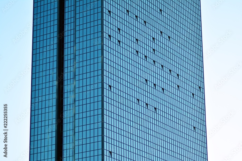 Abstract fragment of contemporary architecture, walls made of glass and concrete. Glass curtain wall