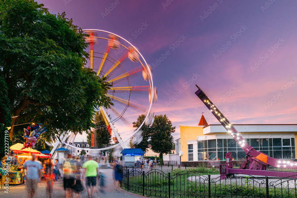 Attraction Ferris Wheel On Summer Evening In City Amusement Park