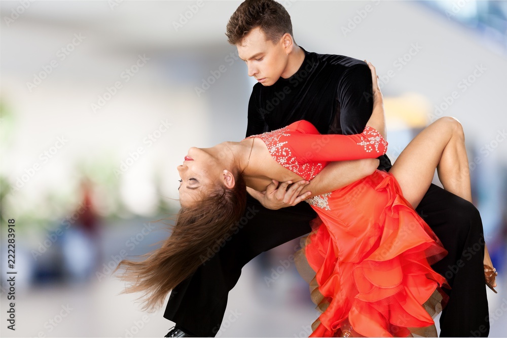 Man and a woman dancing Salsa on background