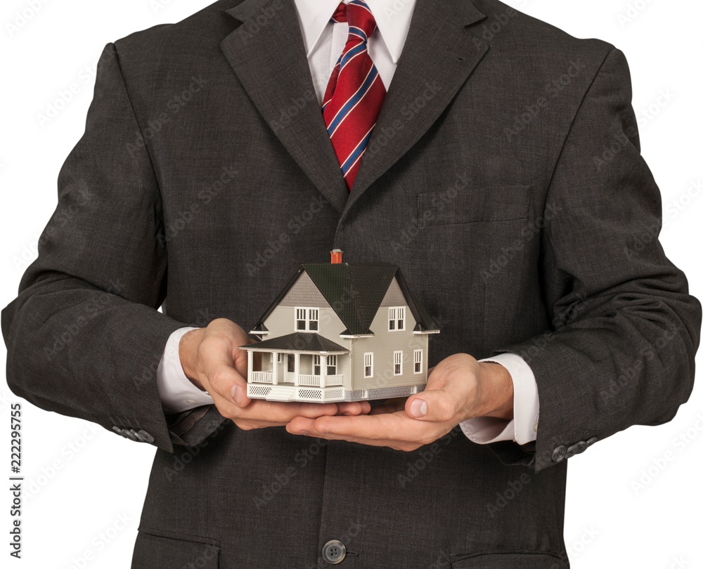 Mens Cupped Hands Holding a Model of a House - Isolated