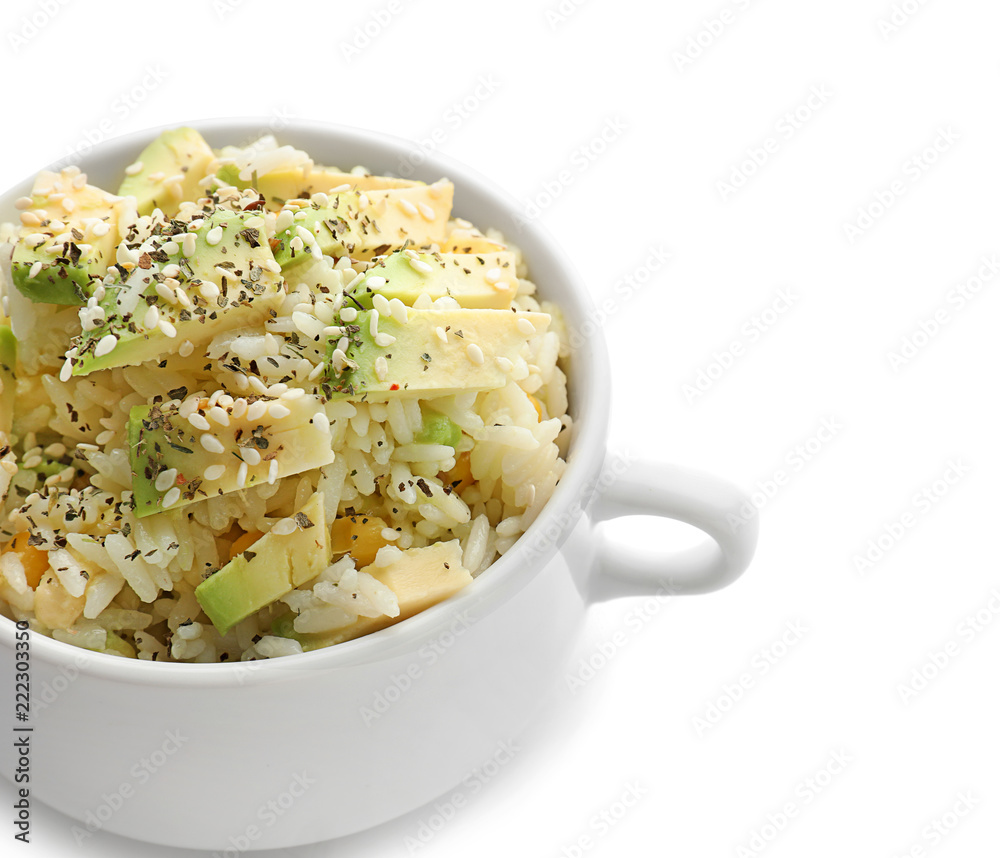 Pot with tasty boiled rice and avocado on white background