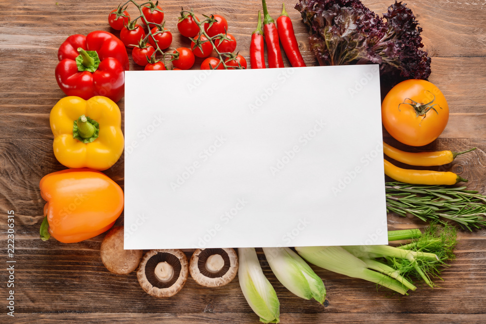 Composition with fresh vegetables and blank card for text on wooden background