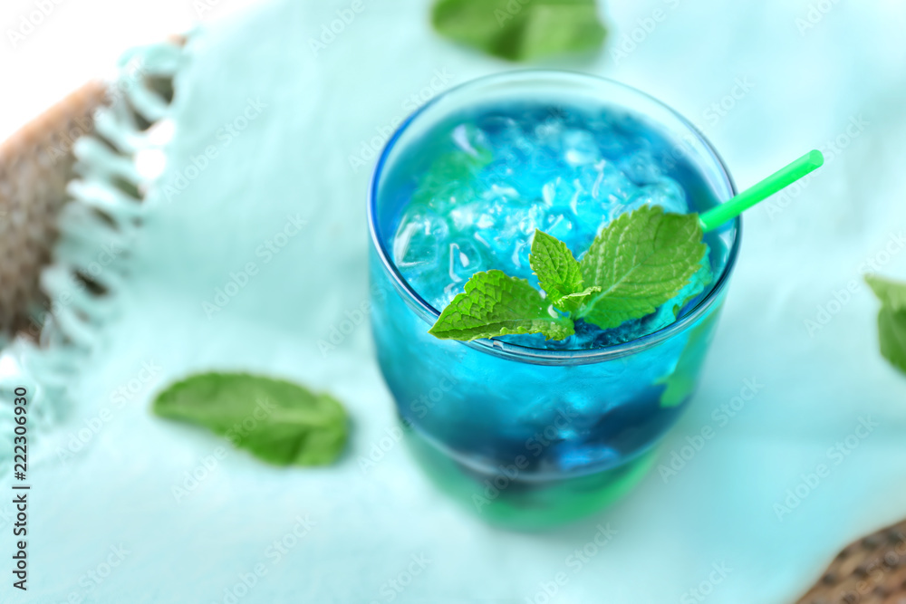 Glass of refreshing summer cocktail on table, closeup