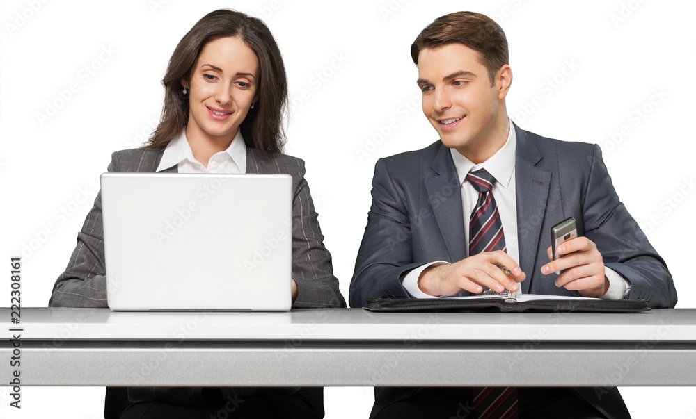 Friendly Coworkers Working at Desk with Laptop and Organizer -