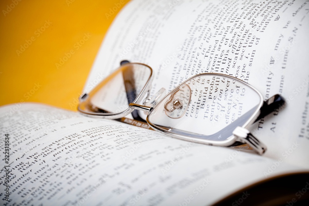 Closeup of Reading Glasses on Book