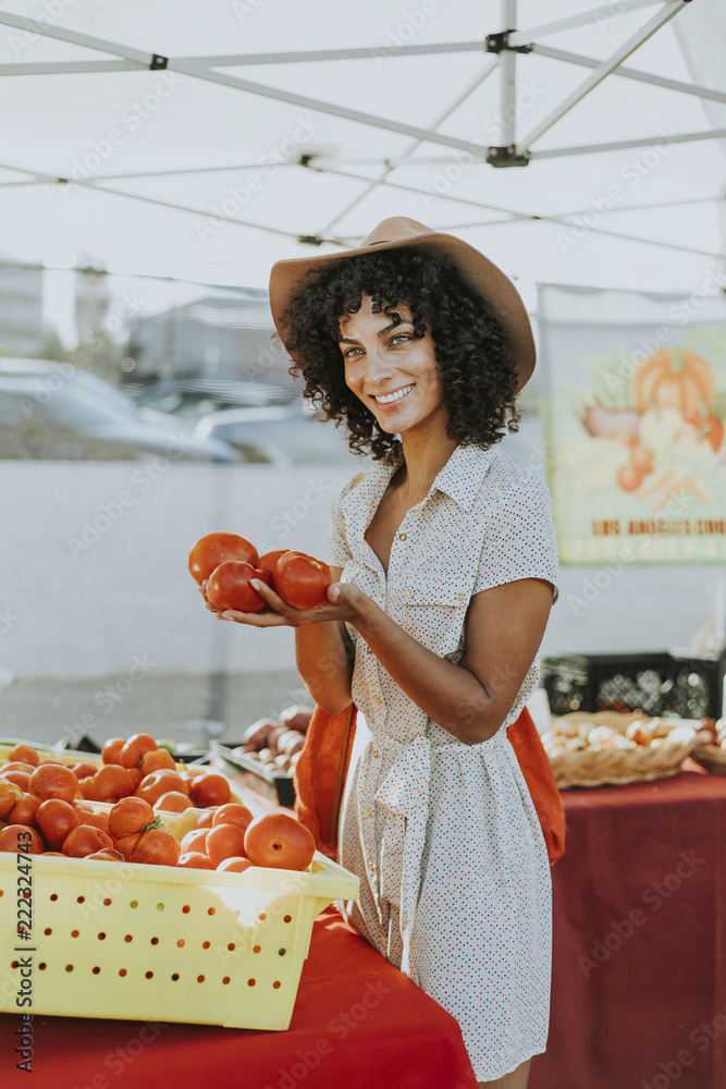 Woman buying tomatoes at a farmers market