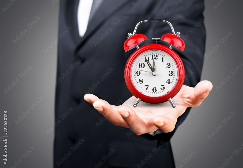 Businessman with clock in time concept