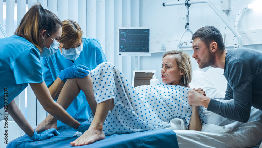 In the Hospital, Woman in Labor Gives Birth, Obstetricians and Doctors Assist, Her Husband Supports 