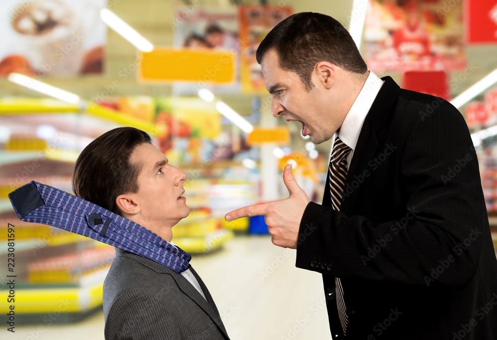 Businessman shouting orders at a worker