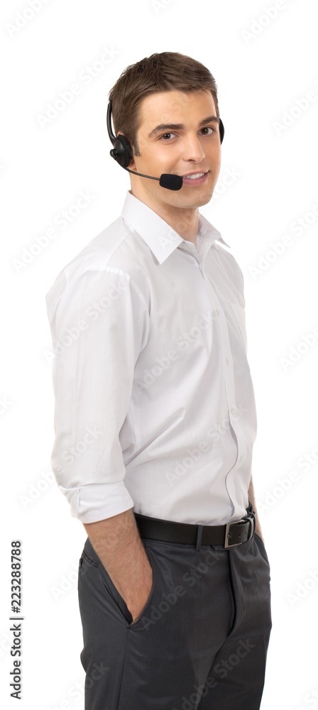 Businessman Using Headset and Standing with Hands in Pockets