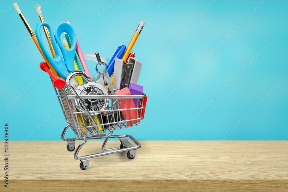 School stationery composition in shopping cart