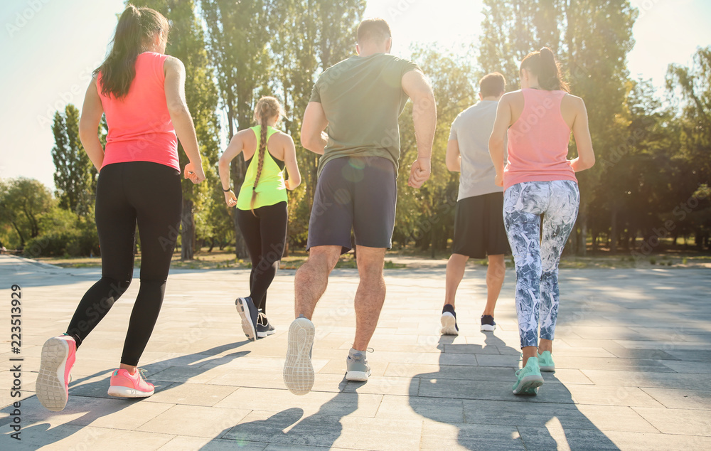 Group of sporty people running outdoors