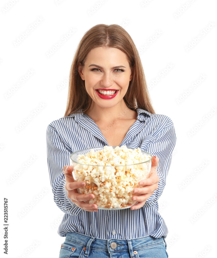 Beautiful young woman with bowl of popcorn on white background