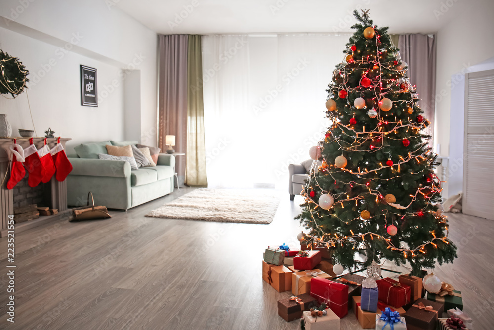 Beautiful decorated Christmas tree in cozy living room