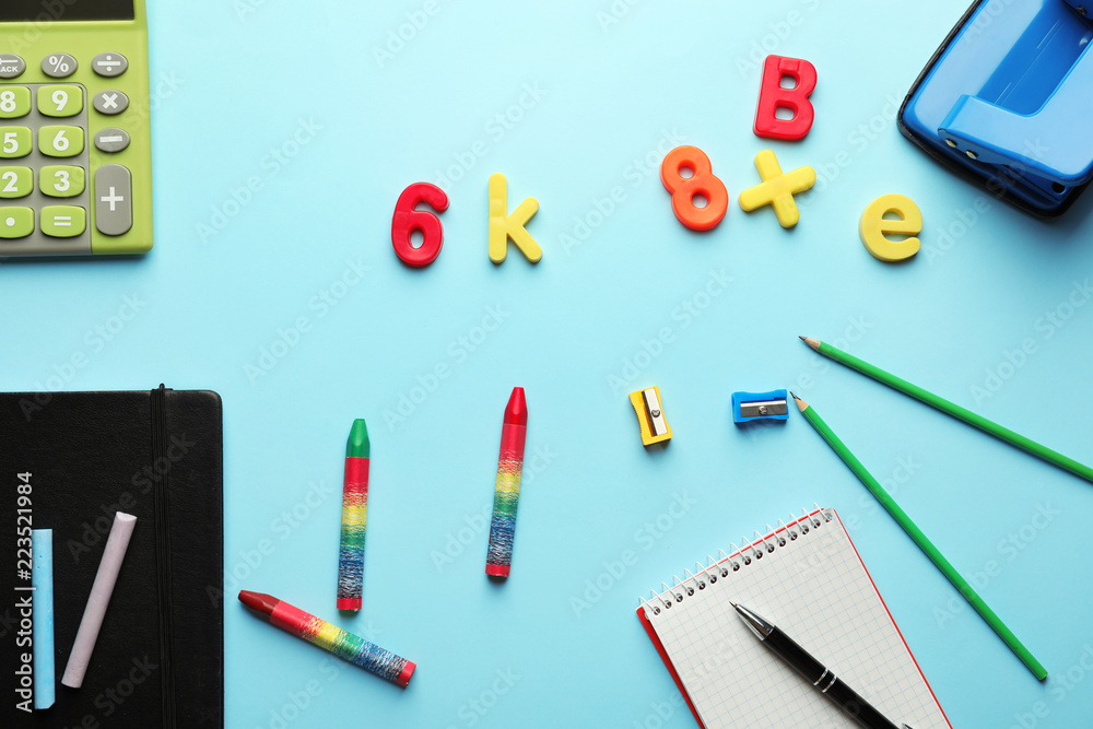 Composition with different school stationery on color background