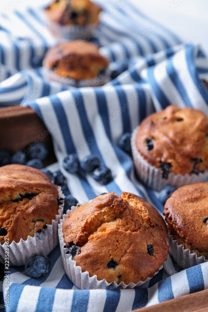 Tasty blueberry muffins on napkin