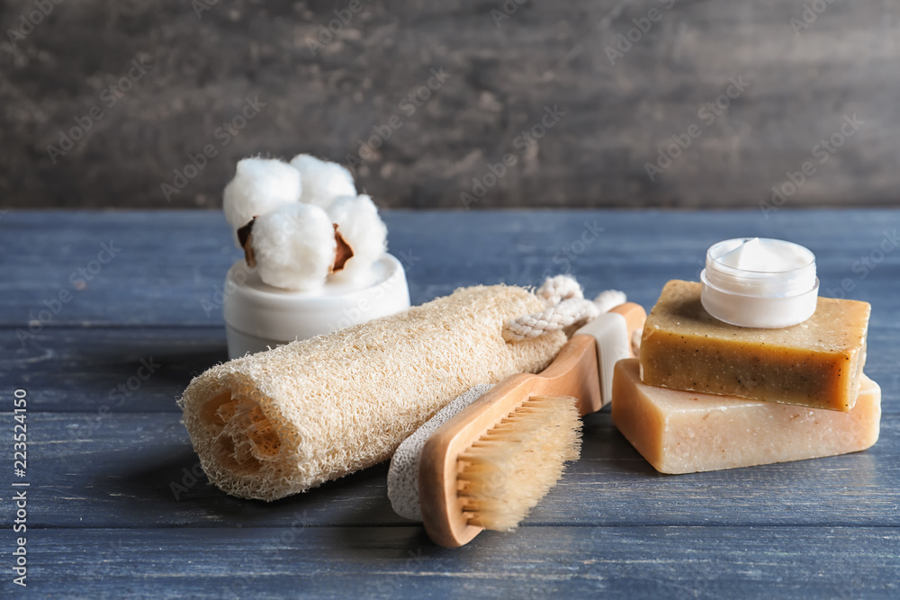 Bath products with loofah and brush on dark wooden table