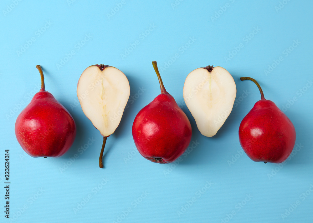 Tasty ripe pears on color background