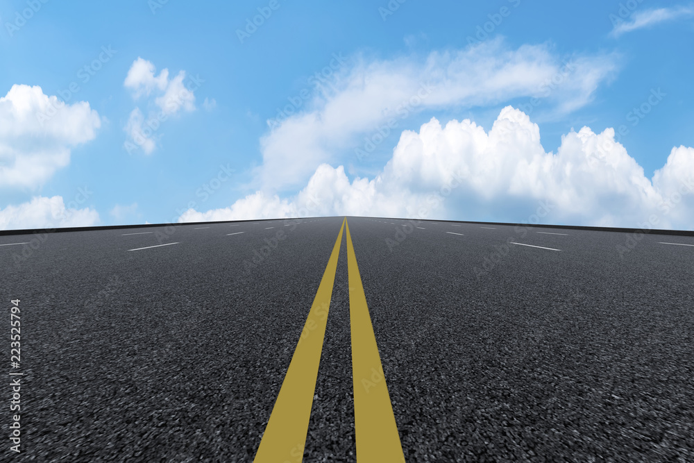 Road pavement under blue sky and white clouds