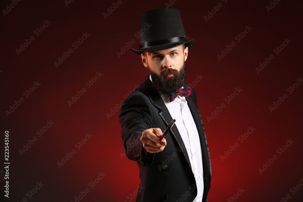 Magician showing tricks on dark background